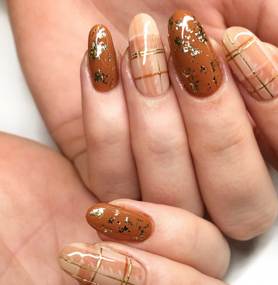 Holiday manicure on long square nails with Golden sequins, black shiny nail  Polish and craquelure matte black coating. Stock Photo | Adobe Stock