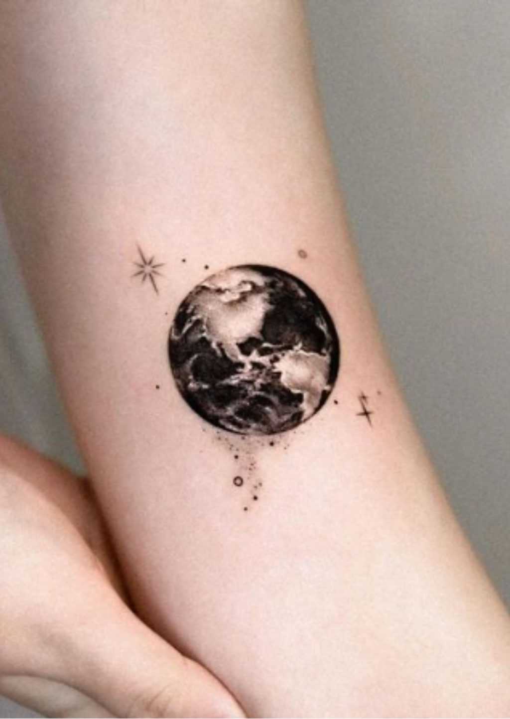 Small earth tattoo on the arm - Tattoogrid.net