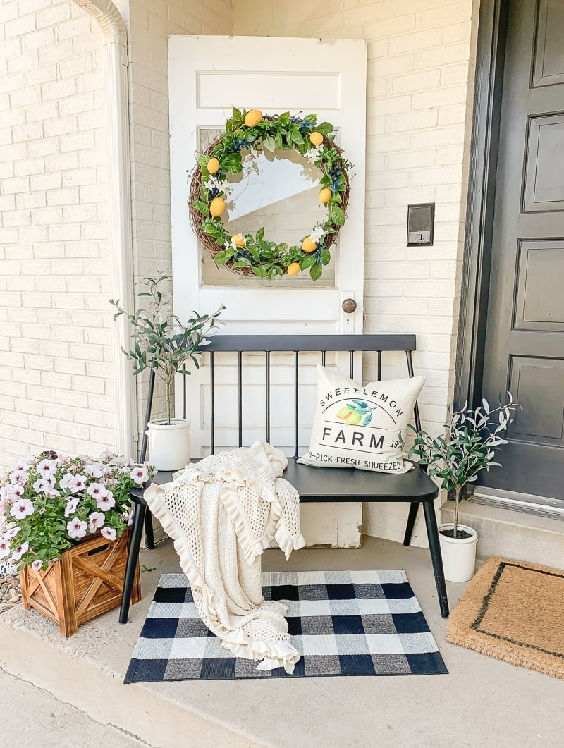 Front porch with seating area, plants and lemon wreath
