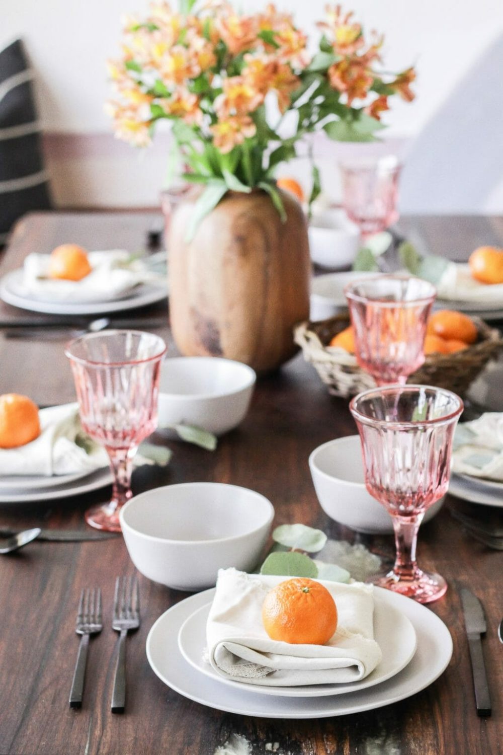 A table setting with fresh oranges on plates