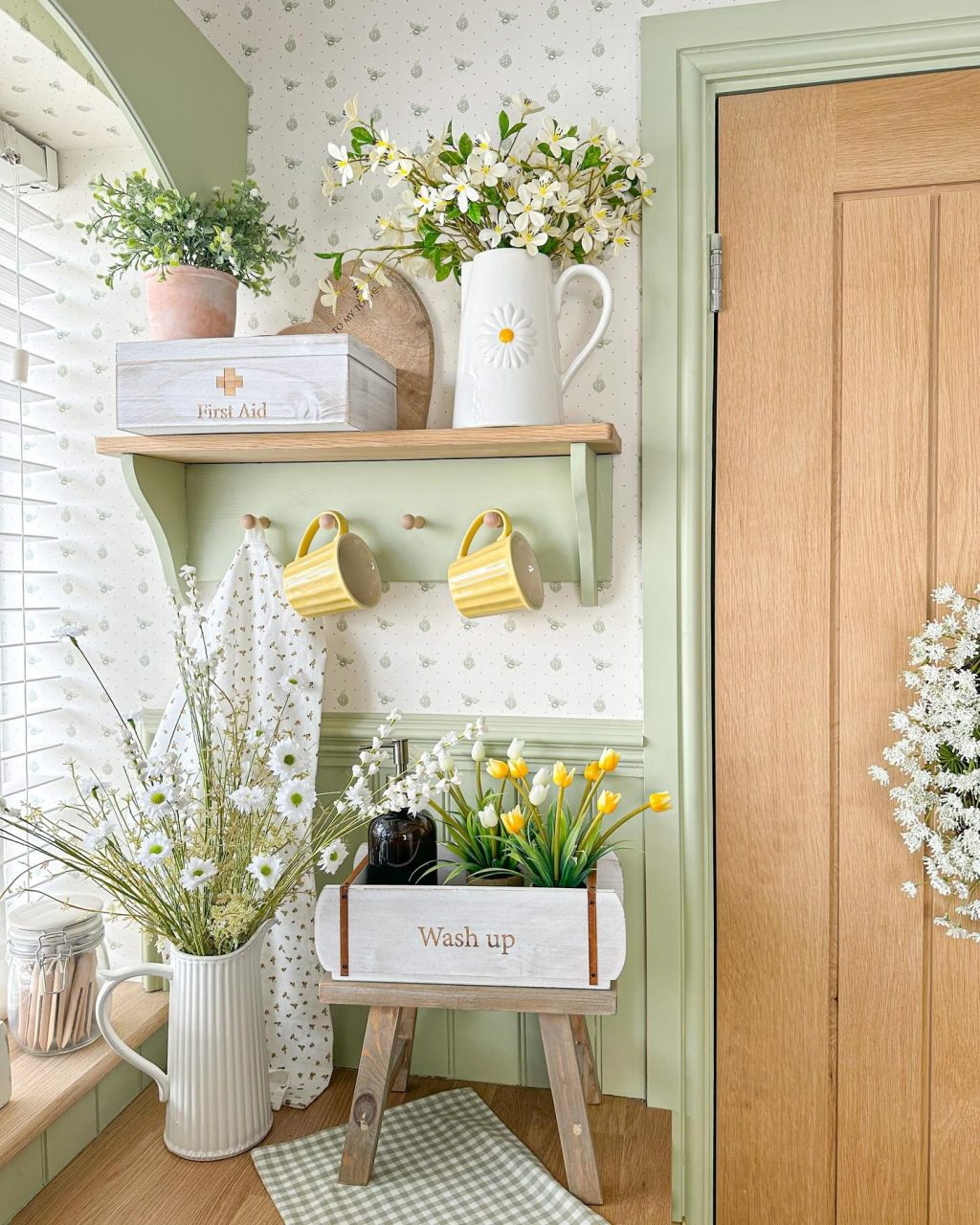 Mint green kitchen with Spring flowers in vases