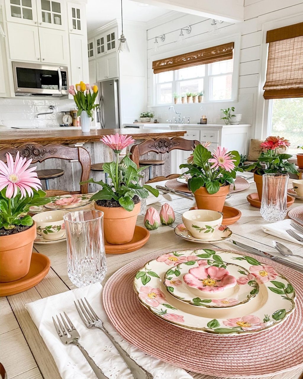 Spring tablescape with potted flowers and floral dishes