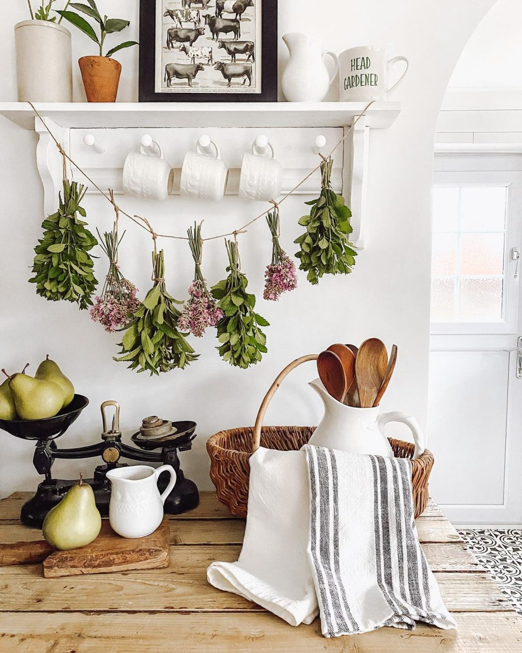 Dried flowers and herbs hanging on a string above a coffee bar